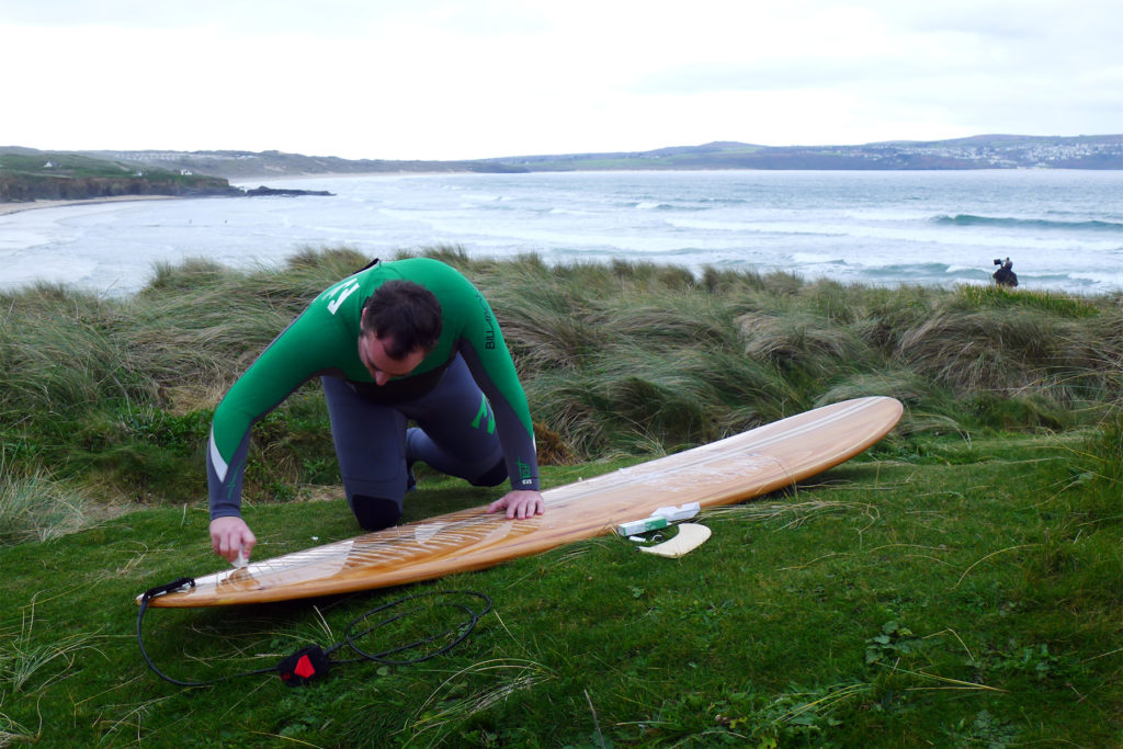 Otter Wooden Surfboard workshop Ian waxing his board