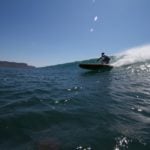 Harris surfing his otter wooden paddleboard