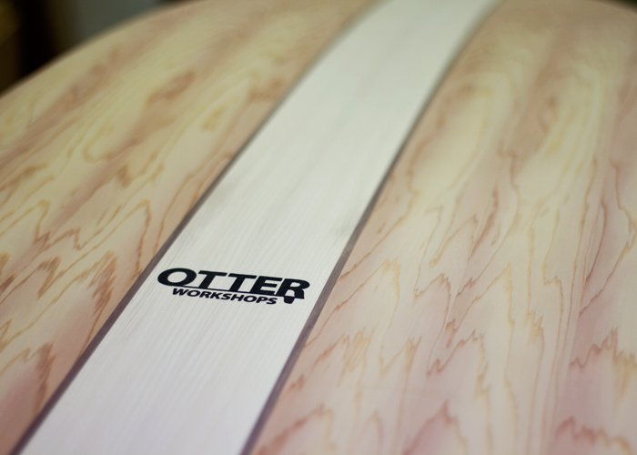 wooden surfboard and wooden fin in the otter surfboards workshop stamped