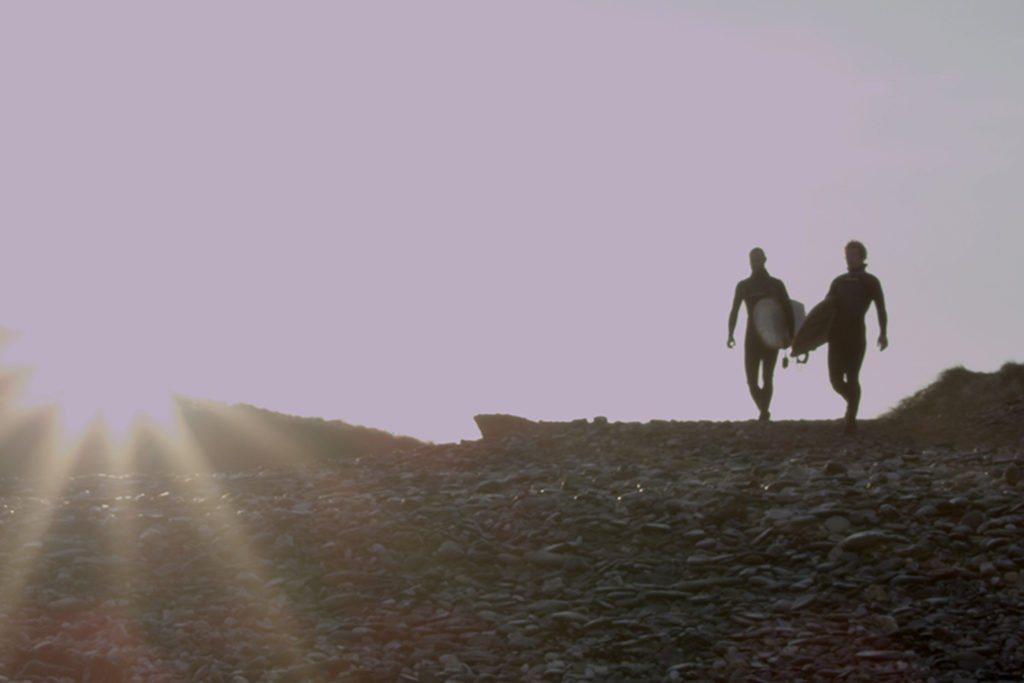 Otter Surfboards and tiny dog film sunrise surfers