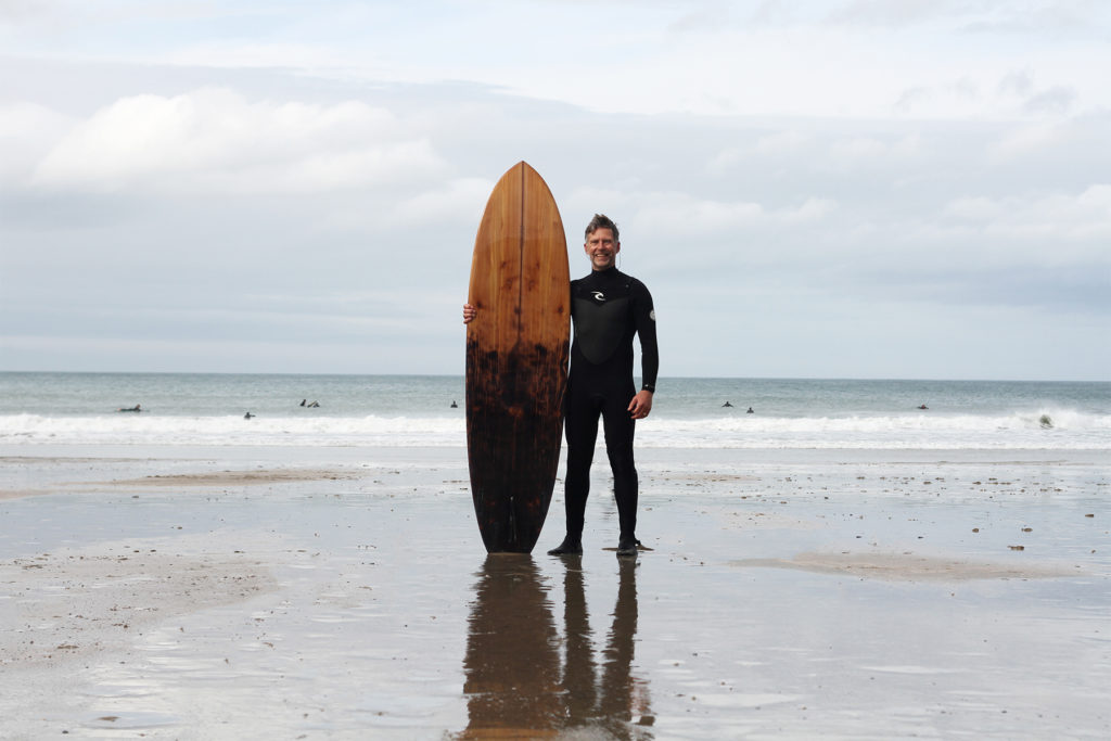 ben cook shou sugi ban otter wooden surfboard burning finished surfboard on the beach