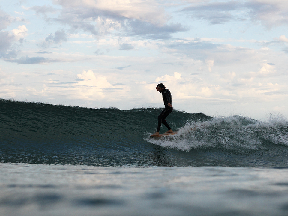Chris Brunt noseriding an otter surfboards wooden longboard