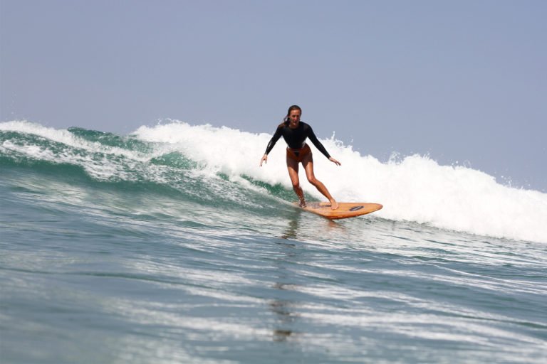 Sarah enjoys a wave on the Fetch at Chapel Porth, Cornwall. Otter Wooden surfboard