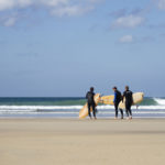 James Otter, Tony and Al on the beach at Godrevy with their wooden surfboards, wicket and coaster