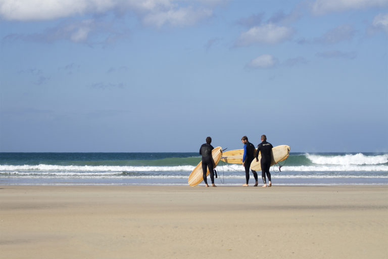 James Otter, Tony and Al on the beach at Godrevy with their wooden surfboards, wicket and coaster