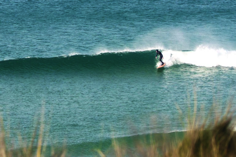 Mat Arney surfing the Otter Surfboards wooden Pier in mid-winter at Gwithian