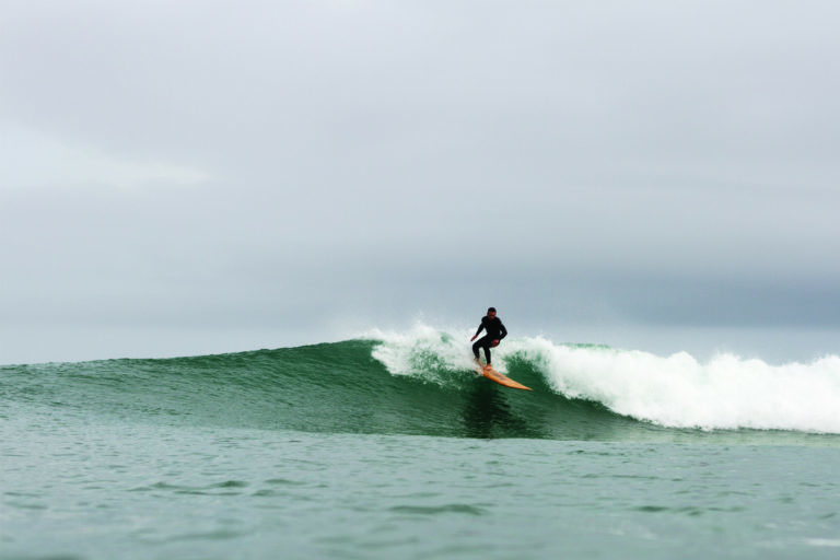 Chris top turns on the Pier. Otter wooden surfboards, Chapel Porth, Cornwall.