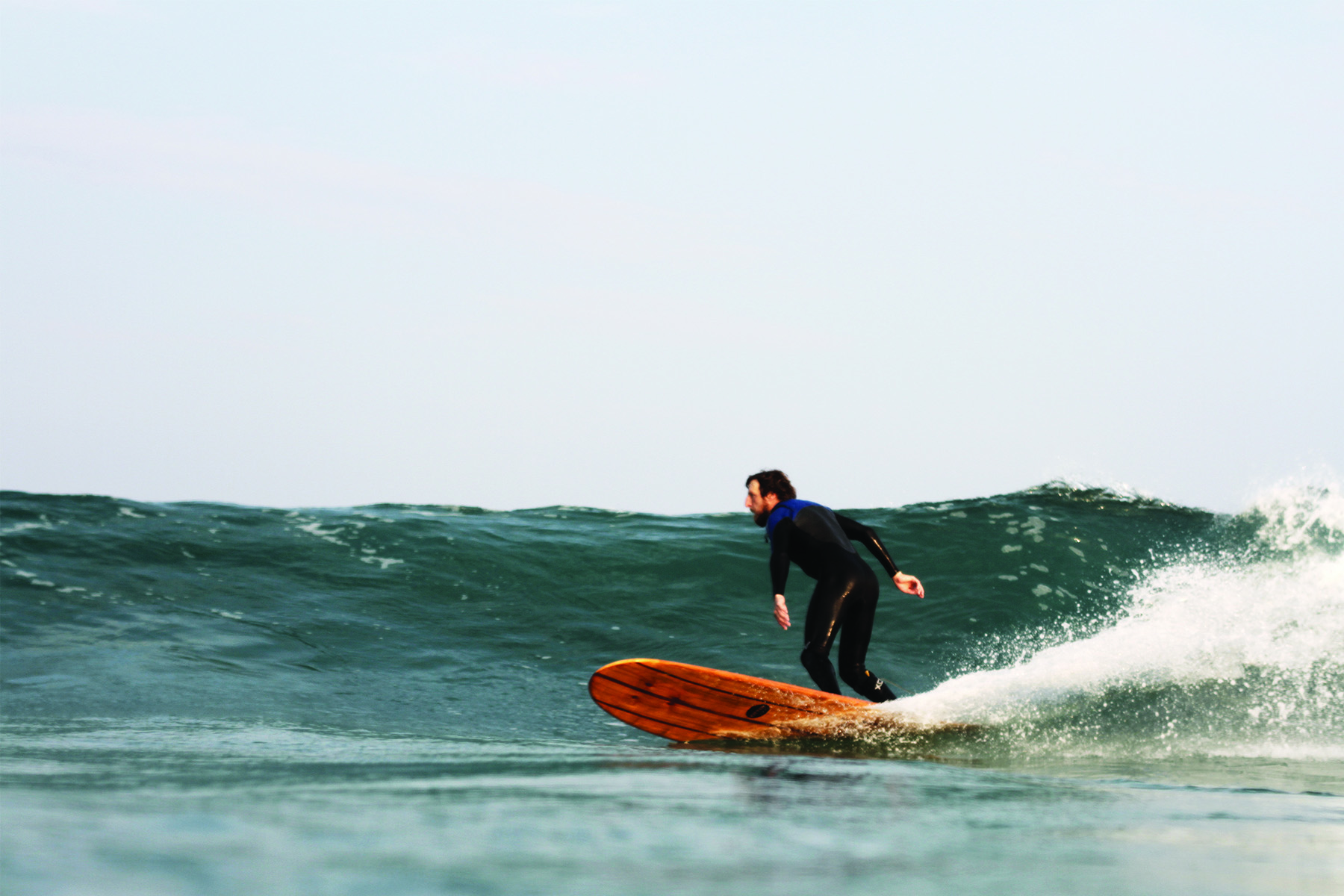 Chris Brunt surfing the Otter Surfboards wooden surfboard Seasaw model.