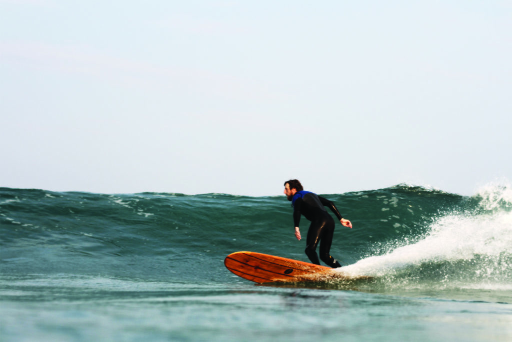 Chris Brunt surfing the Otter Surfboards wooden surfboard Seasaw model.