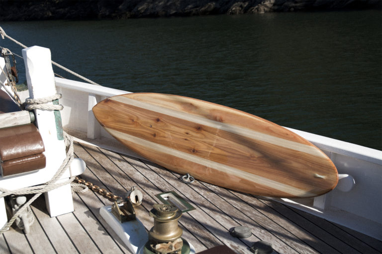 finished wooden surfboard deck otter surfboards workshop cornwall cutter on a pilot cutter boat hesper