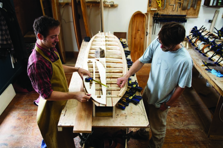 Otter Surfboards wooden surfboard workshop course in Cornwall Duncan talking fin positions on his Barque