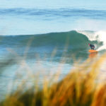 Gideon bottom turns his Otter wooden surfboard at Gwithian. Island Hopper