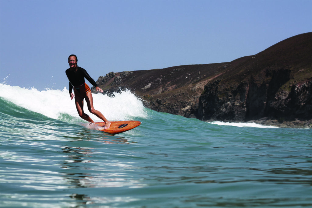 Sarah enjoys a wave on the Fetch at Chapel Porth, Cornwall. Otter Wooden surfboard