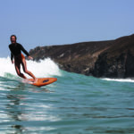 Sarah enjoys a wave on the Fetch at Chapel Porth, Cornwall. Otter Wooden surfboard