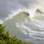 Matt Smith takes cover on an Otter wooden surfboard coaster at St Agnes, Cornwall