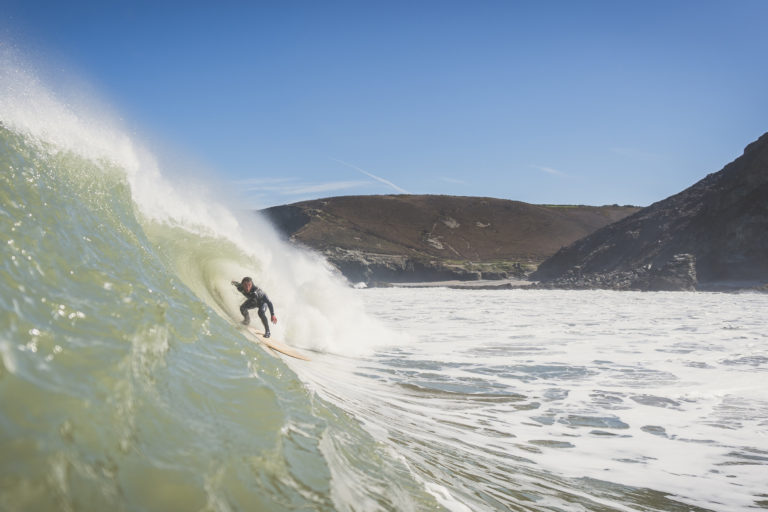 Matt Smith tucking under the lip on an Otter wooden surfboard coaster at St Agnes, Cornwall