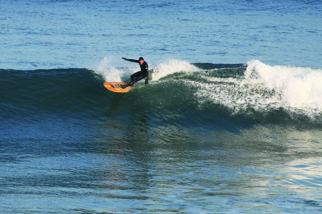 Chris top turns on the Otter Surfboards wooden Jetty at Gwithian, Cornwall