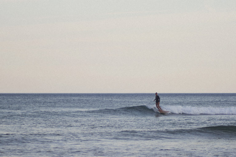 Sarah finding a lonely wave on the otter surfboards Pieces of Eight Wooden surfboard at Chapel Porth, Cornwall