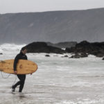 Seadar James Otter Surfing wooden surfboard at Porthtowan walking out