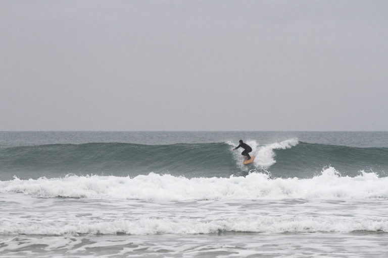 Seadar James Otter Surfing wooden surfboard at Porthtowan dropping in