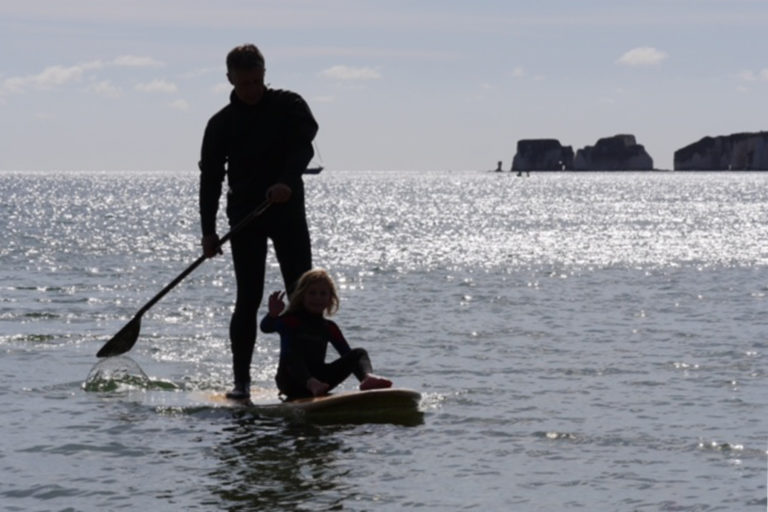 Otter surfboards wooden stand up paddle board on the water with father and daughter