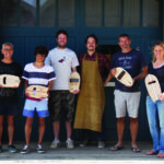wooden bodysurfing handplane workshop group outside the otter surfboards workshop