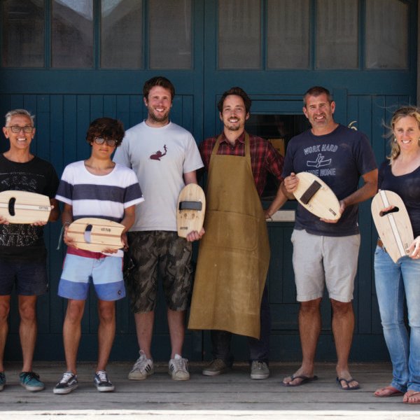 wooden bodysurfing handplane workshop group outside the otter surfboards workshop