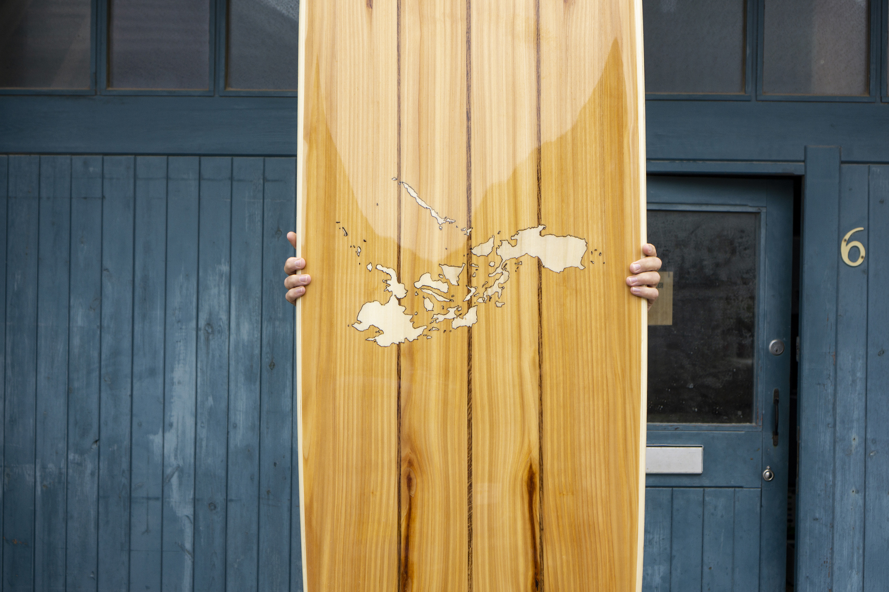 Wooden Longboard Custom Otter Surfboard with Map inlay of Philippines close up of finished board