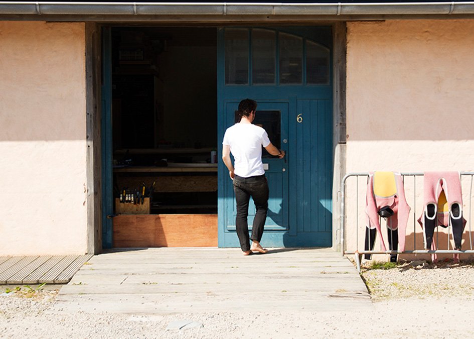Otter Surfboards James surfing Finisterre Nieuwland works wetsuit outside otter workshop