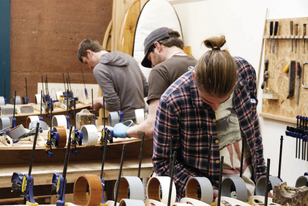 Claudio Pete and Patrick making wooden surfboards in the otter workshop