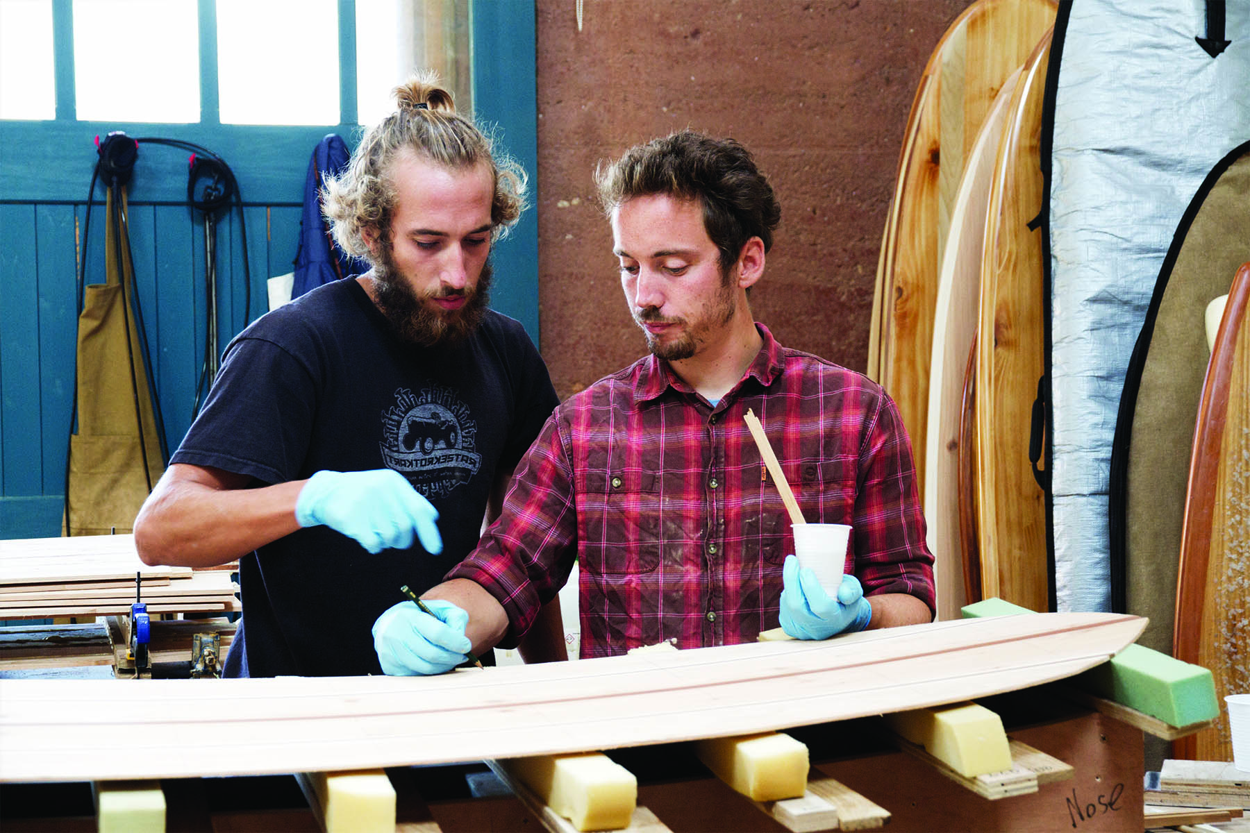 Luca otter wooden surfboard workshop cornwall july 2014 Luca and James gluing frame down