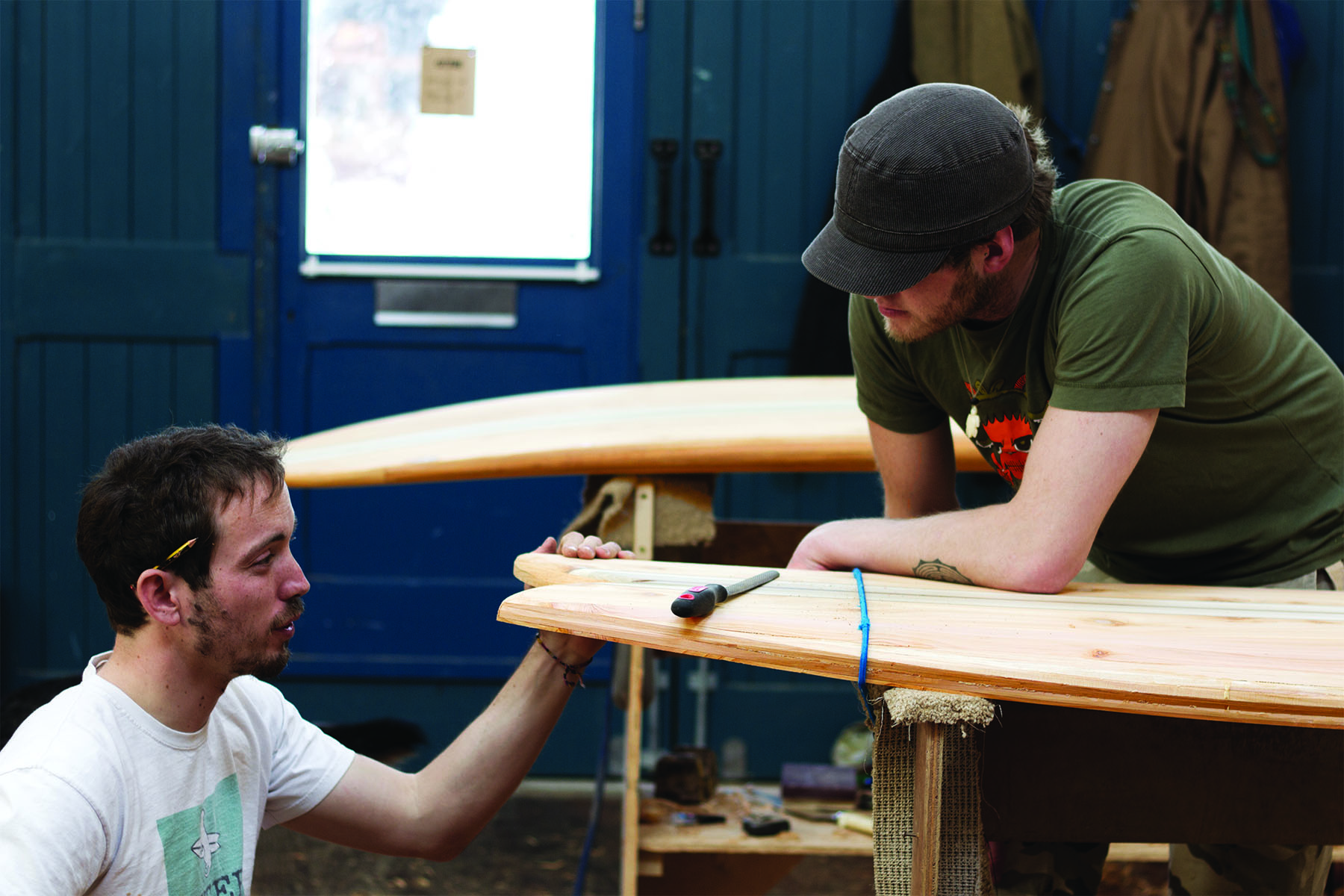 Claudio Pete and Patrick making wooden surfboards in the otter workshop pete and James on tail