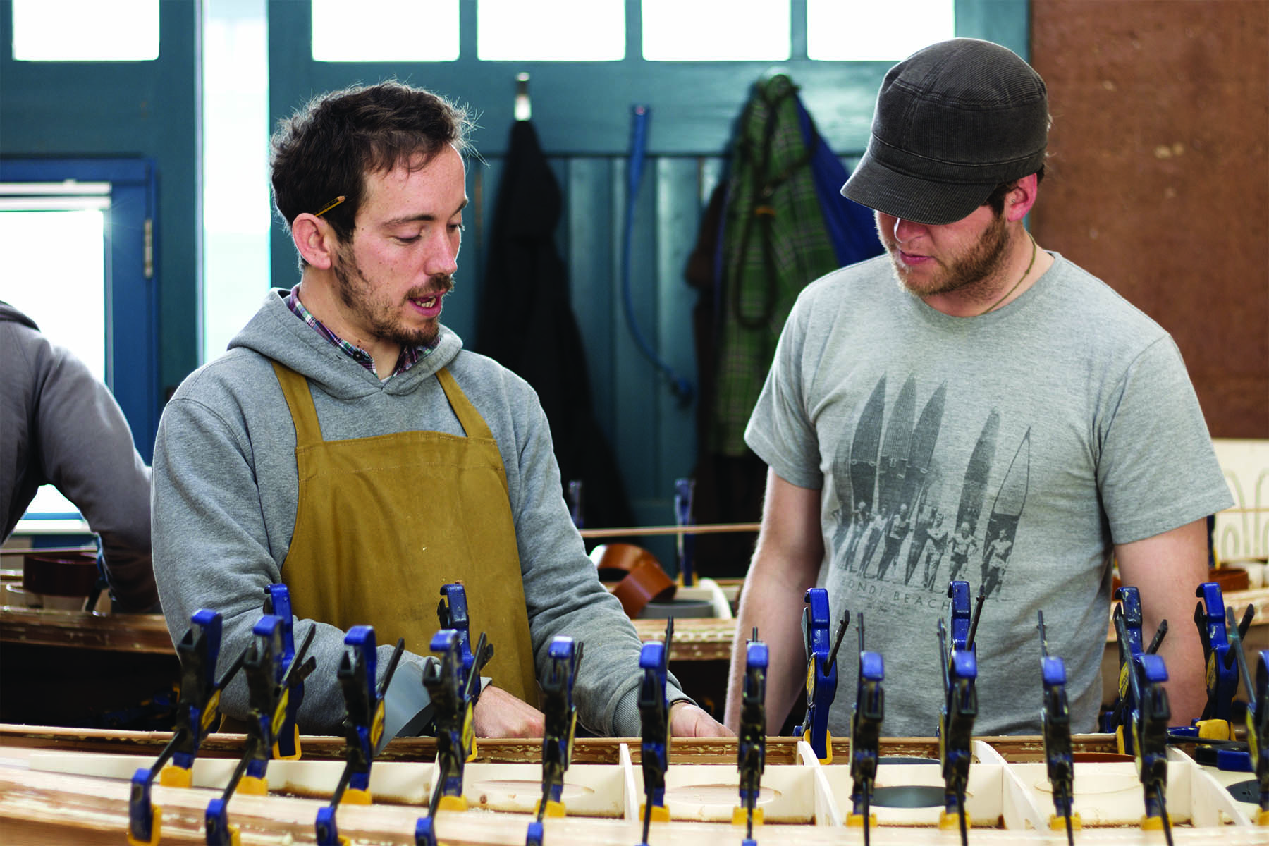 Claudio Pete and Patrick making wooden surfboards in the otter workshop james otter and pete on rails
