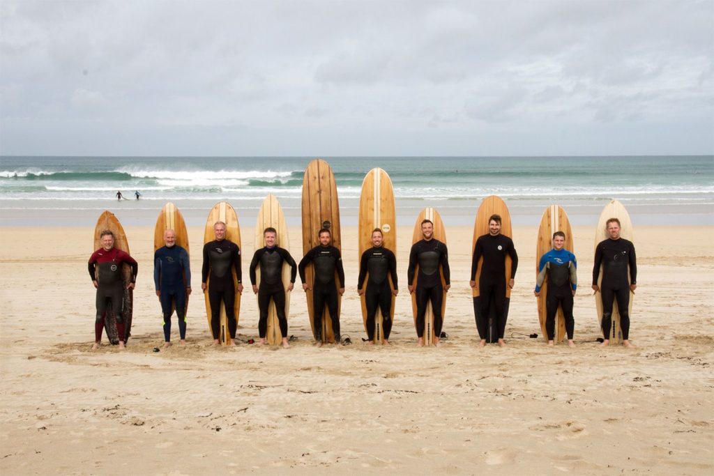 Otter AGM surfers wooden surfboard beach