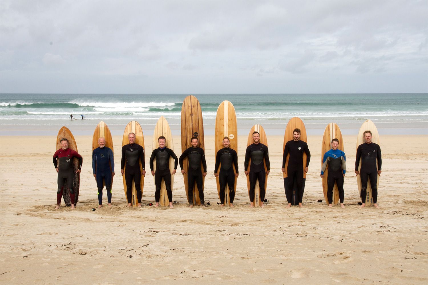 Otter AGM surfers wooden surfboard beach