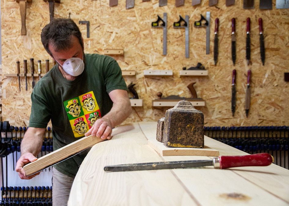 Otter wooden surfboard workshop sanding