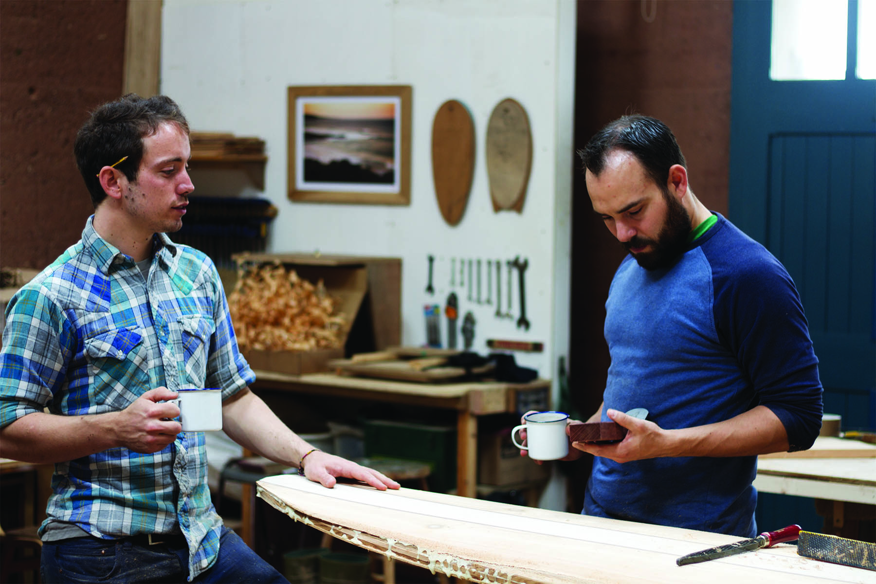 Kim and Shelby wooden surfboard making in the otter workshop in cornwall James and Kim talk over tea