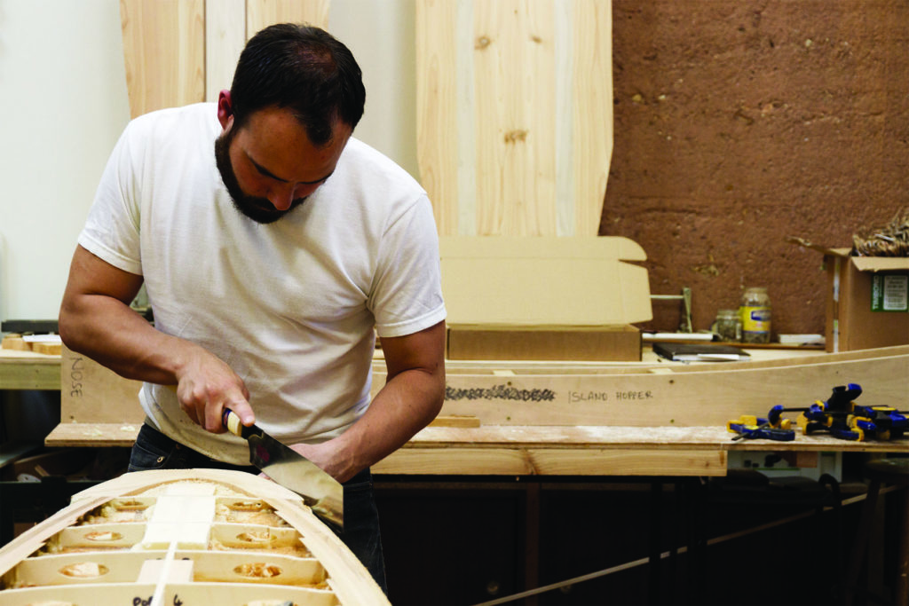Kim and Shelby wooden surfboard making in the otter workshop in cornwall kim cutting tail