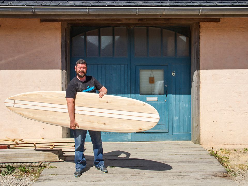 Otter wooden surfboard workshop blue doors