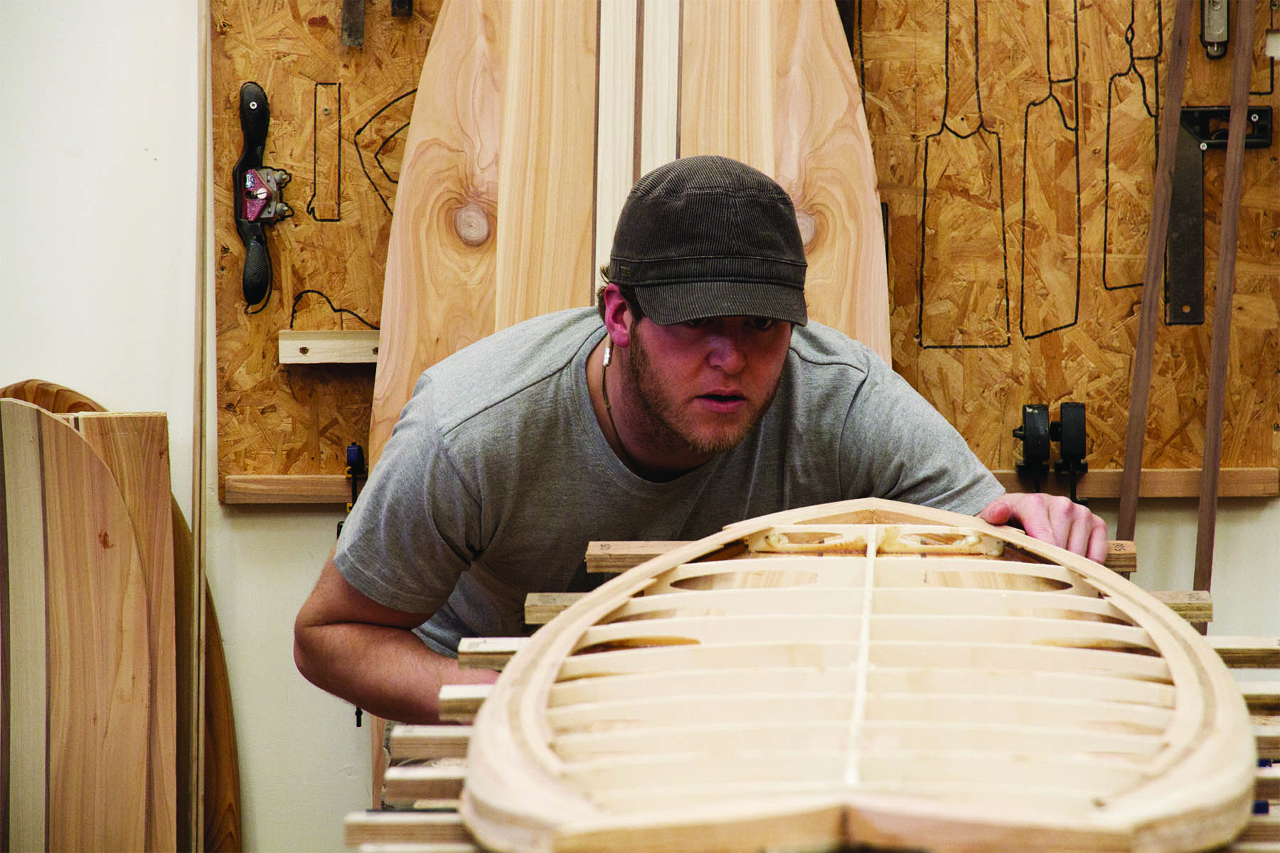 Claudio Pete and Patrick making wooden surfboards in the otter workshop pete checking internal framework