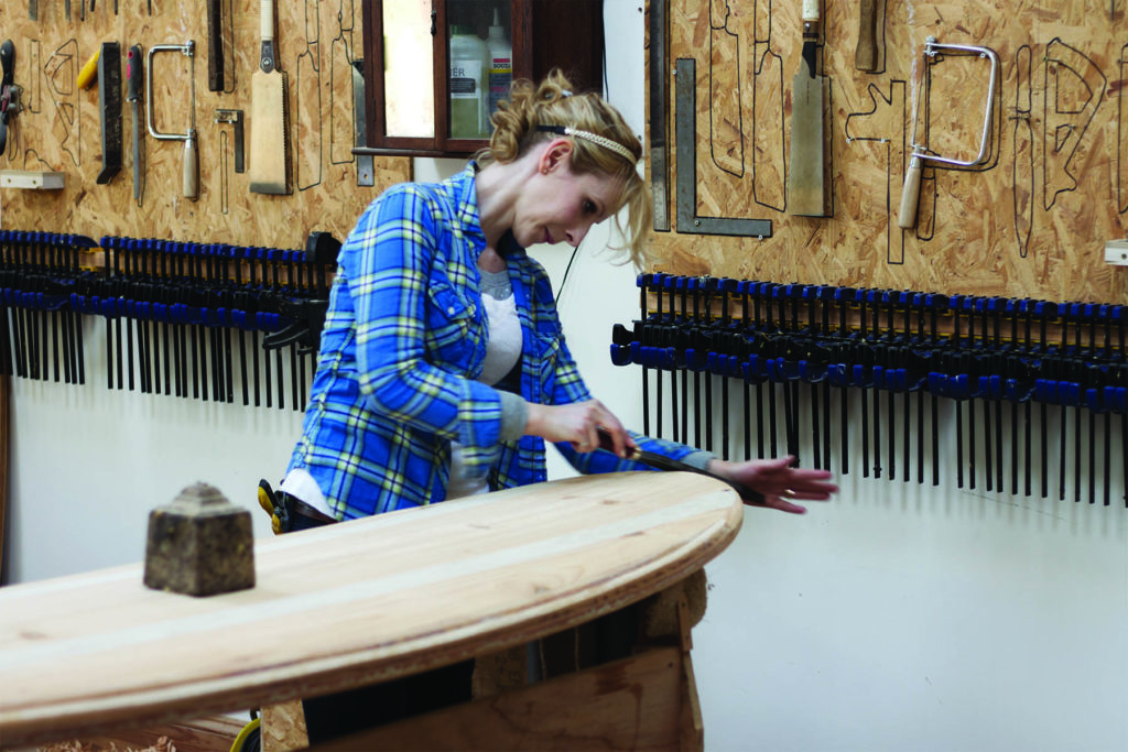 Kim and Shelby wooden surfboard making in the otter workshop in cornwall shelby shaping nose