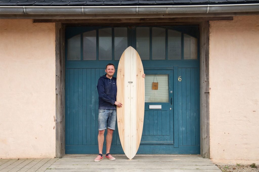 Otter wooden surfboard workshop blue doors