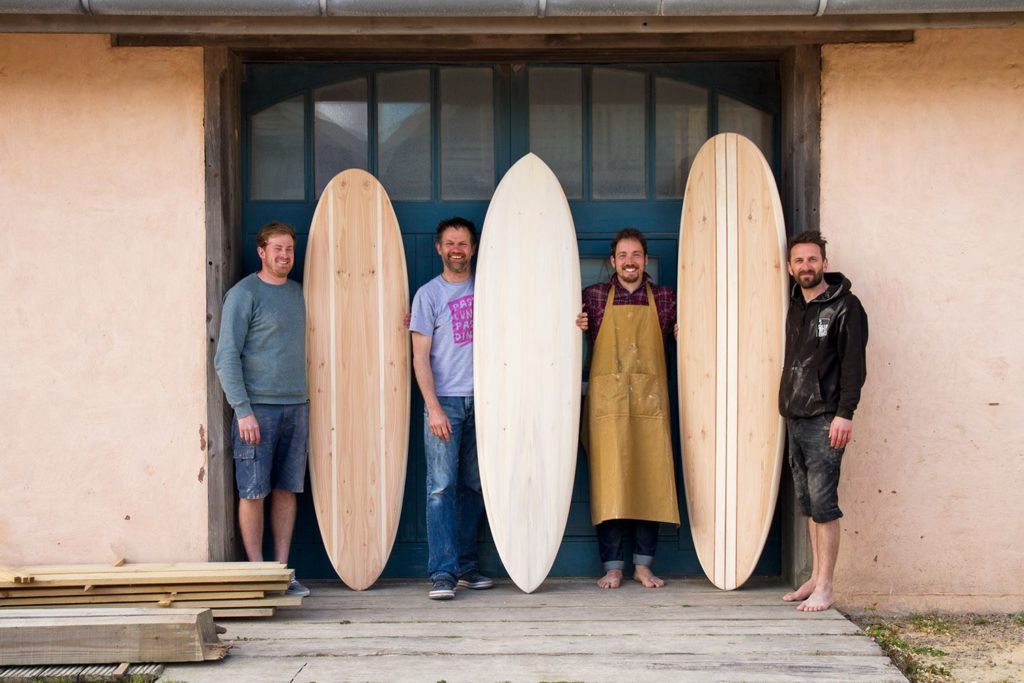 otter wooden surfboard workshop blue doors