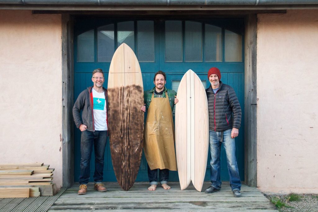 otter wooden surfboard workshop blue doors
