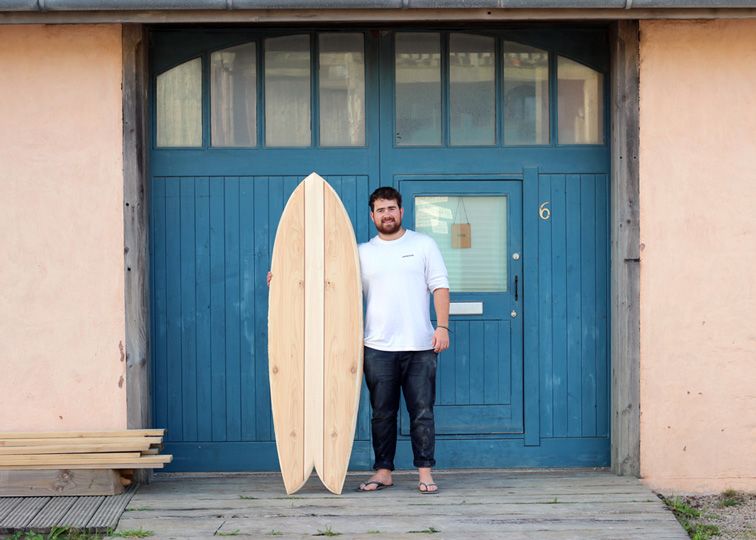 otter wooden surfboard workshop blue doors