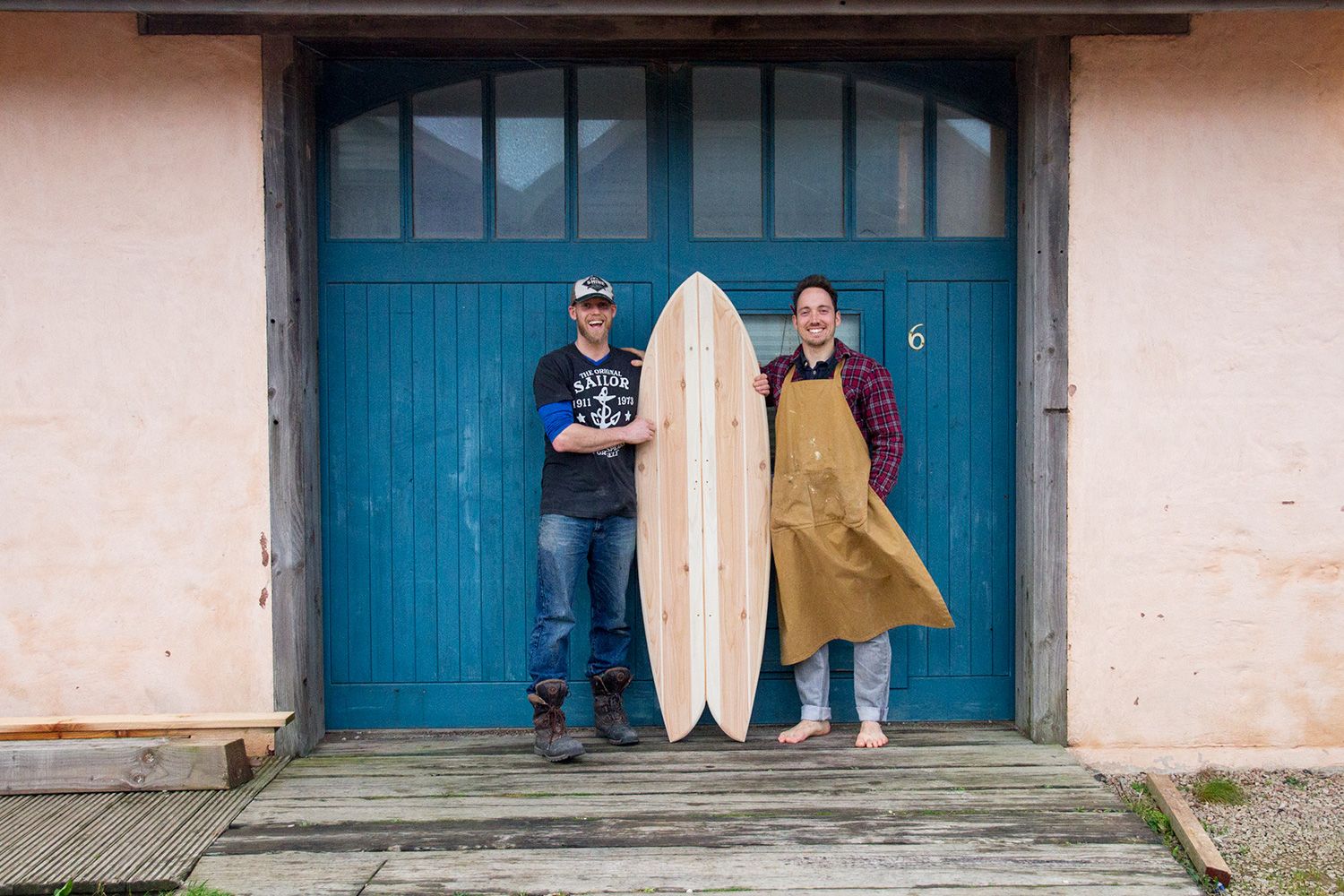 otter wooden surfboard workshop blue doors