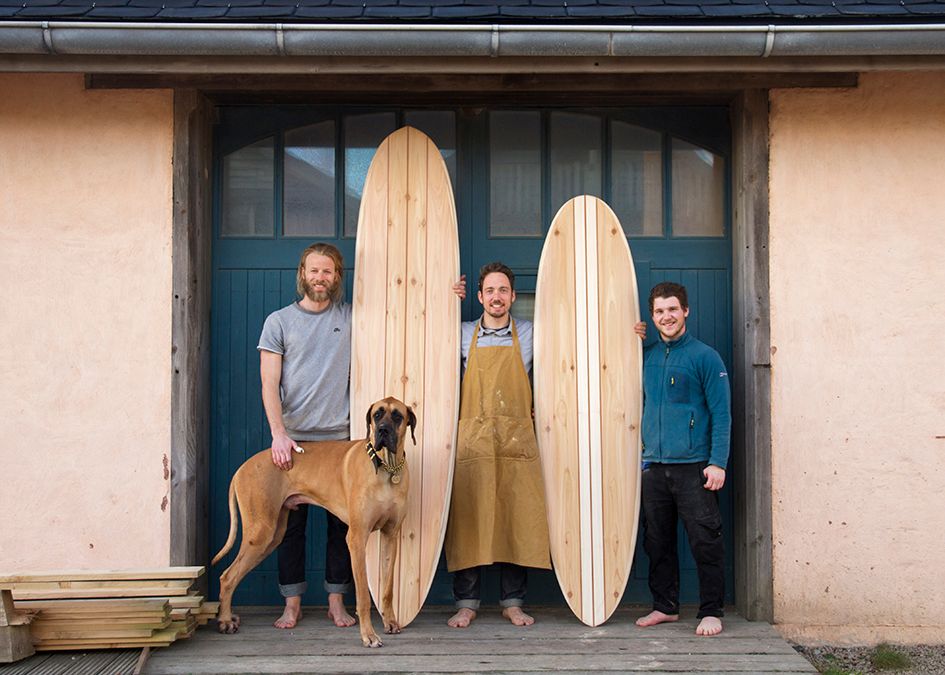 otter wooden surfboard workshop blue doors
