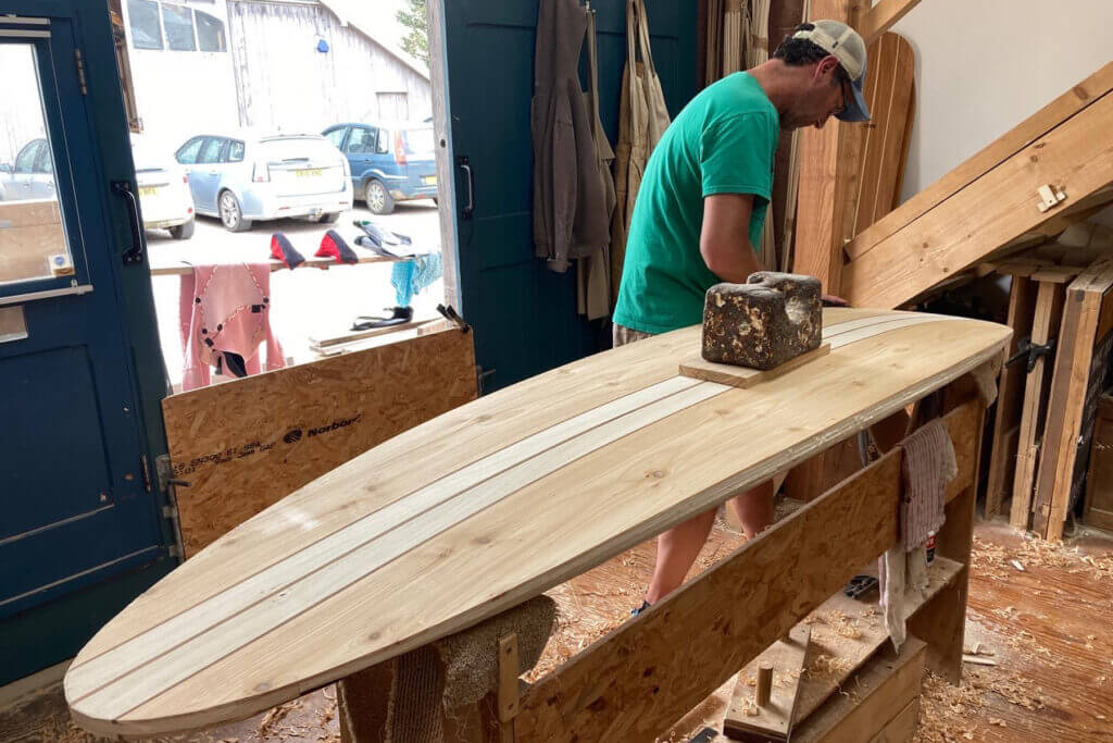 Otter wooden surfboard workshop shaping