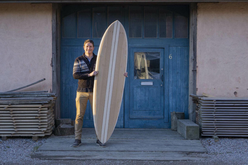 otter wooden surfboard workshop blue doors