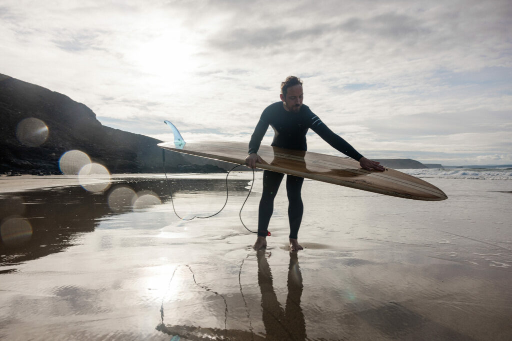 otter wooden surfboards beach longboard sustainable surfer